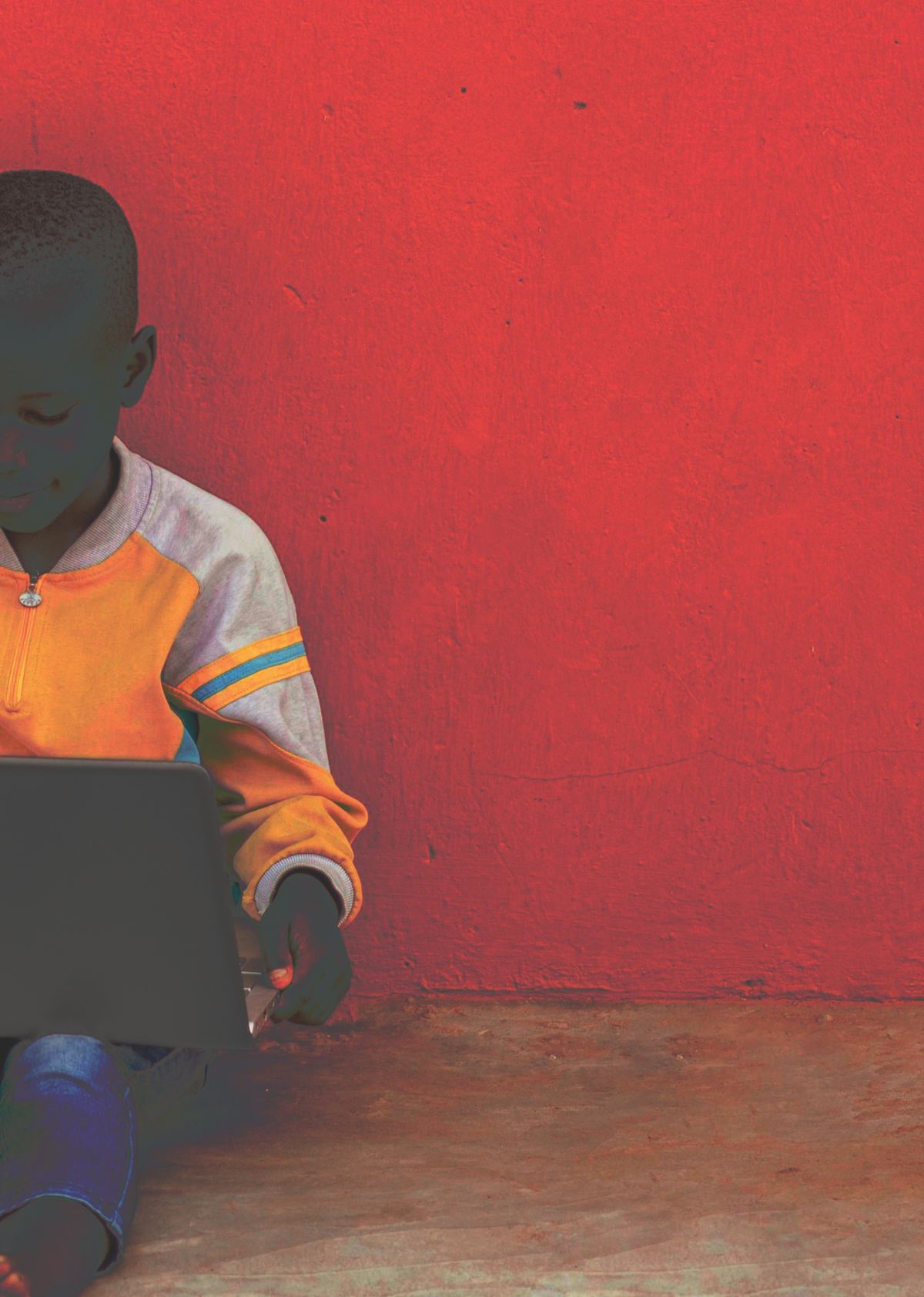 Two students sharing a laptop outdoors